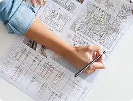 Person analysing technical drawings and schematics of a project for automatic doors.