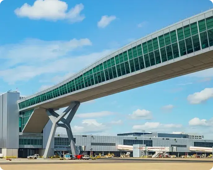 Glazed elevated walkway that connects an airport terminal with the boarding area.