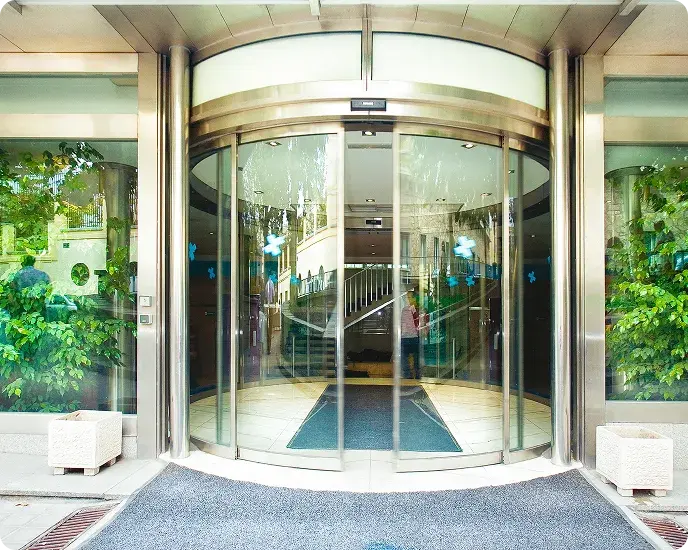 Automatic revolving glass door at building entrance